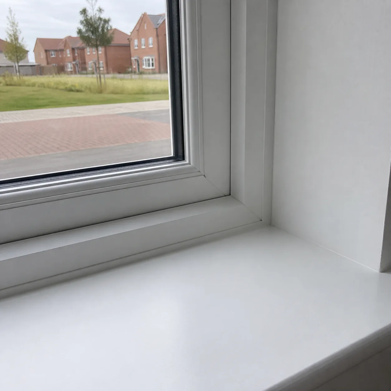 A spotless white light switch beside a painted door frame, wiped to inspection standard